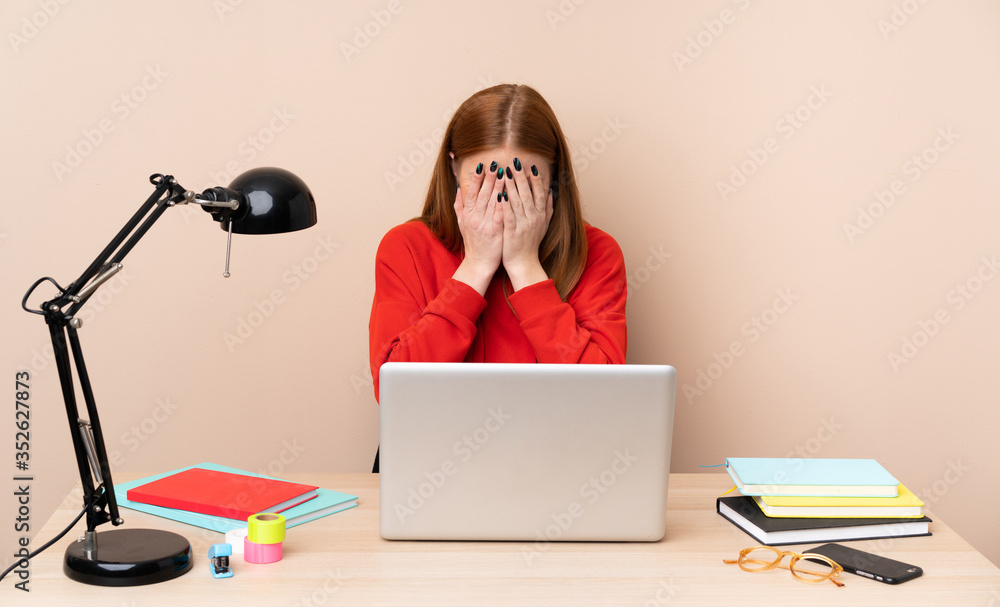 Young student woman in a workplace with a laptop with tired and sick expression Young student woman in a workplace with a laptop with tired and sick expression