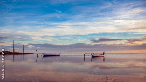small fishing boats on the pond of Ayrolle near Gruissan at sunset. photo