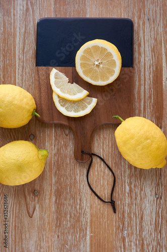 Top view of lemons on rustic wooden table. Copy space