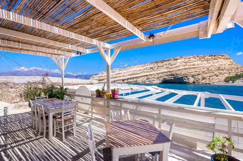 Fototapeta Naklejka Na Ścianę i Meble -  Matala beach with caves on the rocks that were used as a roman cemetery and at the decade of 70's were living hippies from all over the world, Crete, Greece