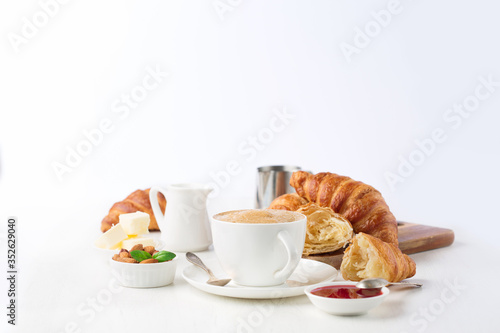 Fresh delicious breakfast with coffee and croissants