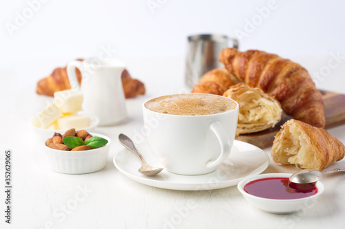 Fresh delicious breakfast with coffee and croissants