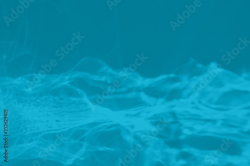 Trendy mint blue colored low contrast abstract background with light and shadows caustic effect. Light passes through a glass. Water background. 2021 year color trend