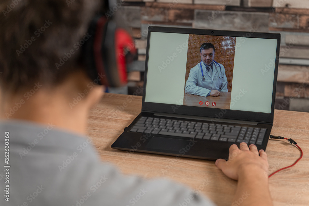 Young man talking with doctor on laptop Young man talking with doctor on laptop