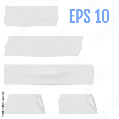 Slices of a white adhesive tape with shadow and wrinkles.