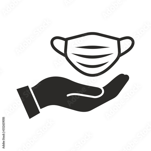 Medical face mask in hand icon. Personal protective equipment, PPE. Vector icon isolated on white background.