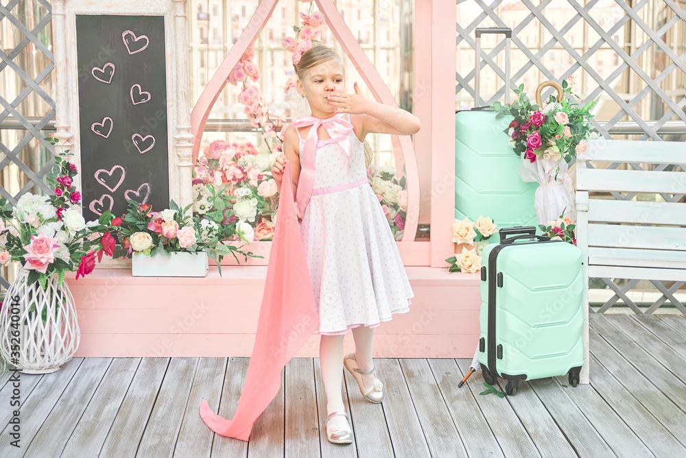 Fototapeta premium nice little girl blows a kiss. the child meets the passenger