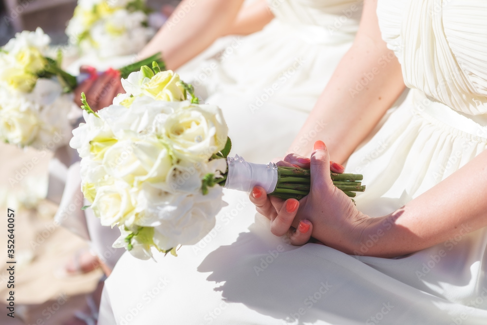 Bridesmaids at the wedding with a beautiful bouquet of flowers in their hands. Bridesmaids at the wedding with a beautiful bouquet of flowers in their hands.