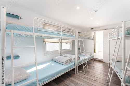 Clean bedroom with bunk beds in a hotel, a hostel for tourists.