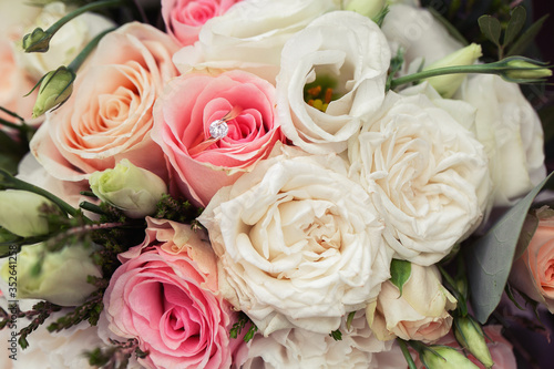 Perfect image with copy space for chic boho wedding magazines and websites  bohemian  fashion  florist. Flowers bouquet with nude roses and wedding rings. Copy space. Flowers background.