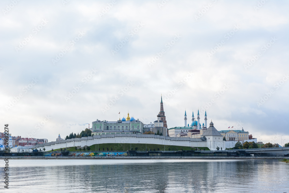 Fototapeta premium View of the Kazan Kremlin with Presidential Palace, Annunciation Cathedral, Soyembika Tower, Qolsharif Mosque from the embankment. The cloudy day.