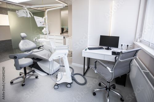 Modern Dental Clinic, Dentist chair and other accessories used by dentists in medical light. Dental surgeon, is a surgeon . Dentist's office. Dental equipment in modern, clean interior © MONIUK ANDRII
