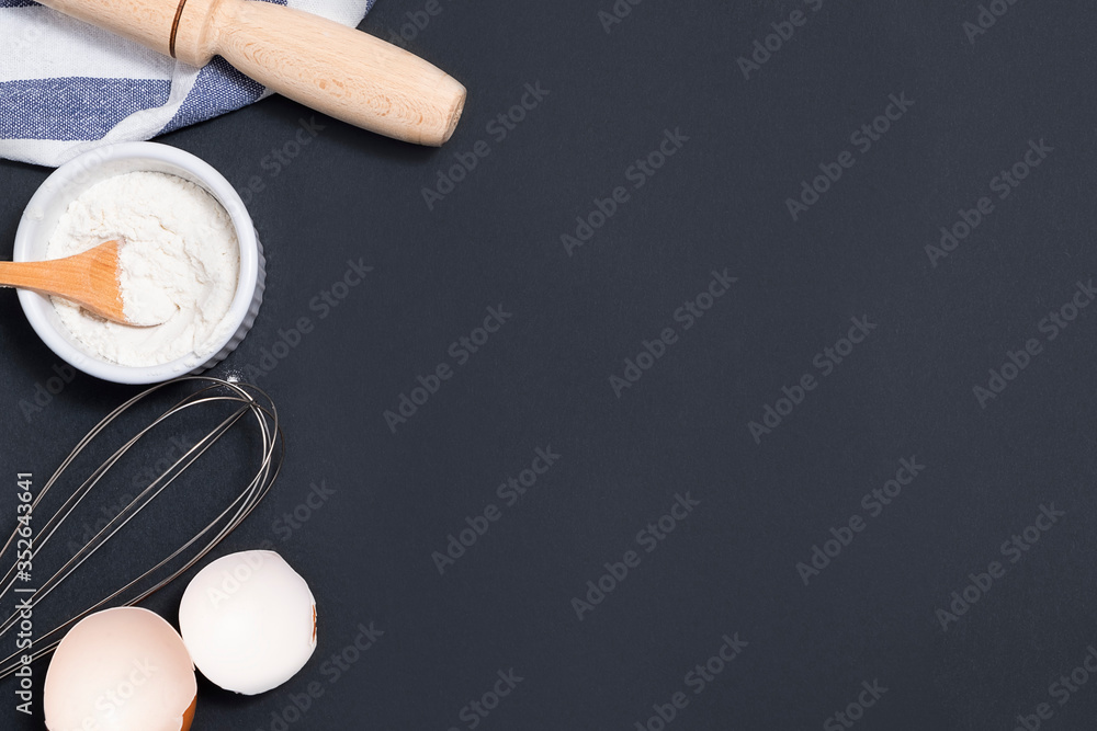 Top view of backing background with flour, rolling pin, eggshells, utility whisk Top view of backing background with flour, rolling pin, eggshells, utility whisk