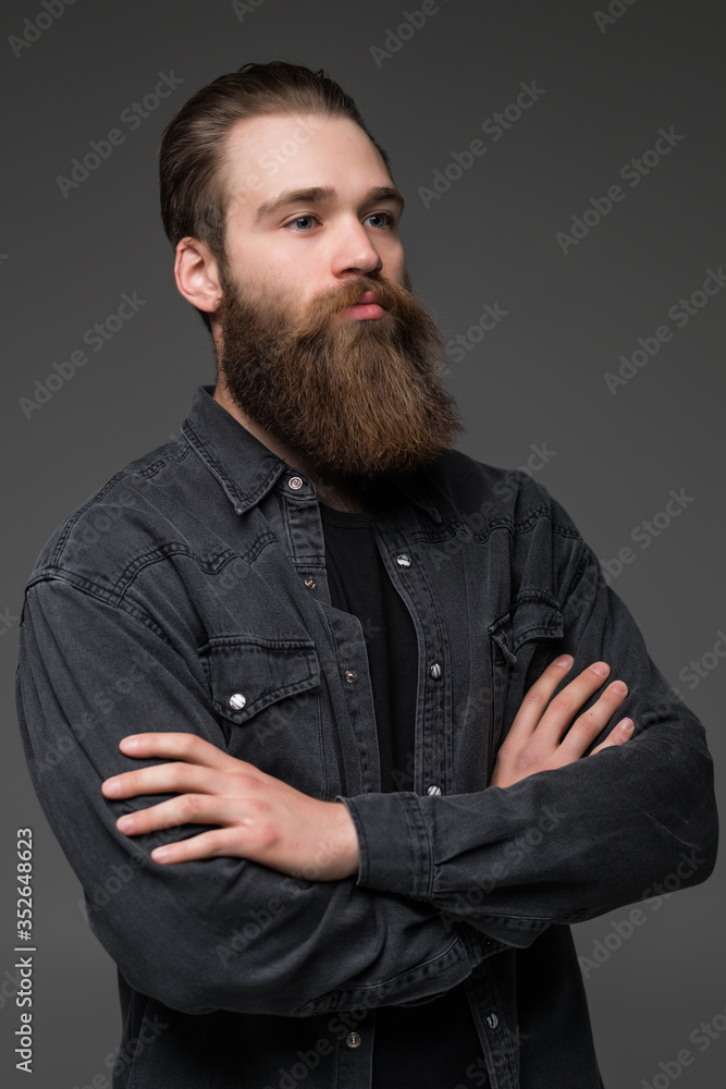 Attractive long beard man hands crossed isolated grey background Attractive long beard man hands crossed isolated grey background