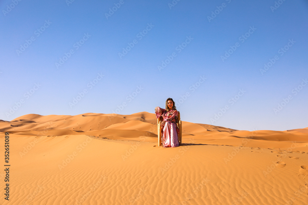 A girl in a beautiful Moroccan dress. Merzouga Morocco.
