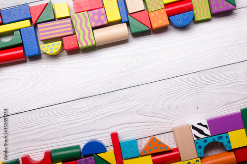 Kids educational developing toys frame on white background. Top view. Flat lay. Copy space for text photo