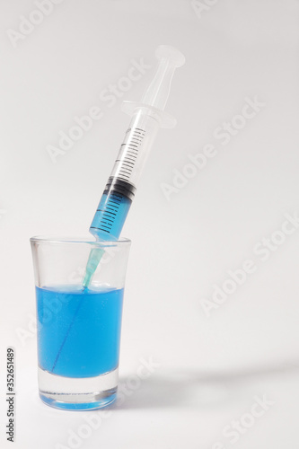 Laboratory tests. Syringe with blue toxin. New antiviral drug.