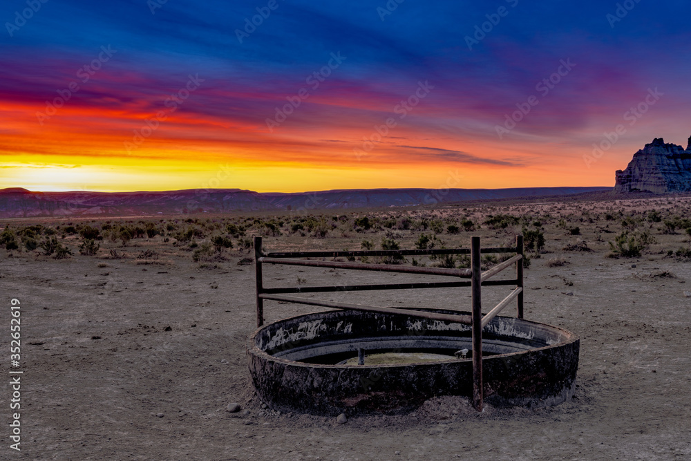Sunrise over a cattle watering trough in the desert