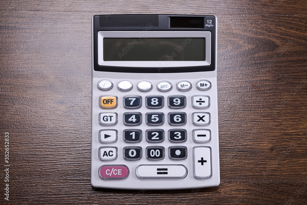 Calculator keypad on a wooden floor background. Top view. Copy space Calculator keypad on a wooden floor background. Top view. Copy space