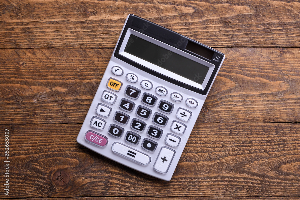 Calculator keypad on a wooden floor background. Top view. Copy space Calculator keypad on a wooden floor background. Top view. Copy space