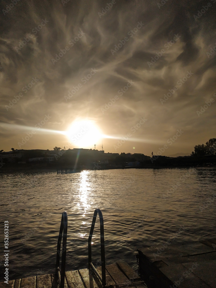 Obraz premium handrails for descent into the sea at sunset