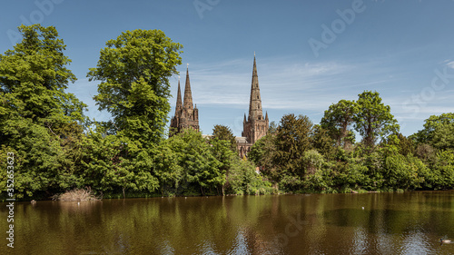 A view of the three spires of Lichfield cathedral in Staffordshire from across Minster pool