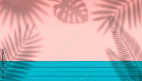 Empty wooden table and pink wall background with torpical tree leaves shadow photo