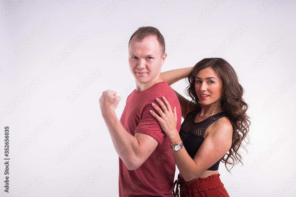 Portrait of young healthy sporty couple hugging on white background. Portrait of young healthy sporty couple hugging on white background.