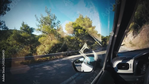 Driving a car on a mountain road on a hot sunny day. Peloponnese, Greece. 
Color graded.