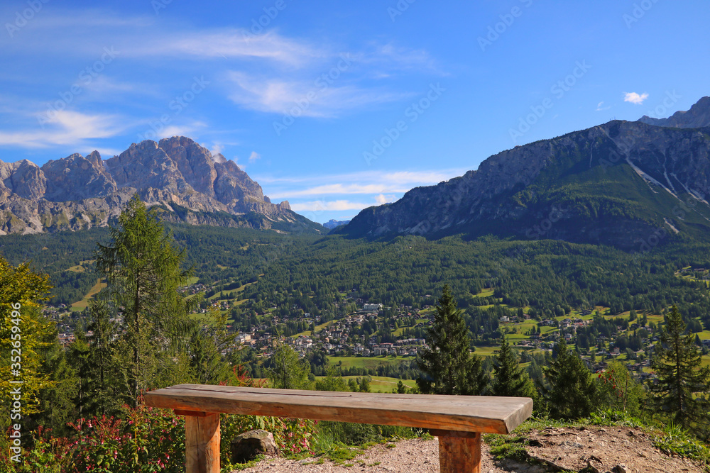 wooden bench with amazing view on Dolomiti. Selective focus.