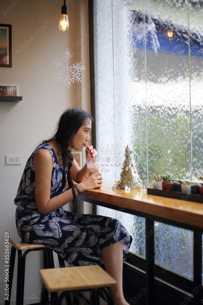 Woman drinking iced coffee using straws Woman drinking iced coffee using straws