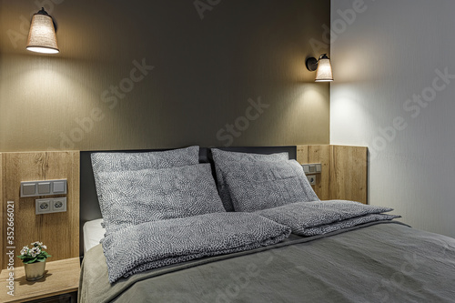 Double bed lamp and modern pillows in interior