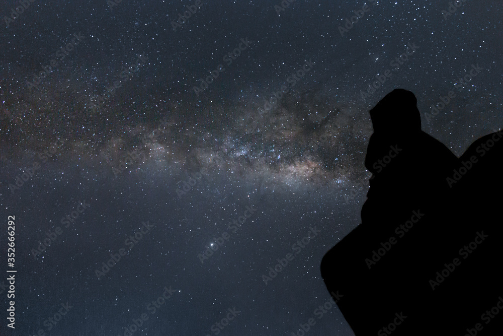 silhouette of person gazing the galactic center of the milky way