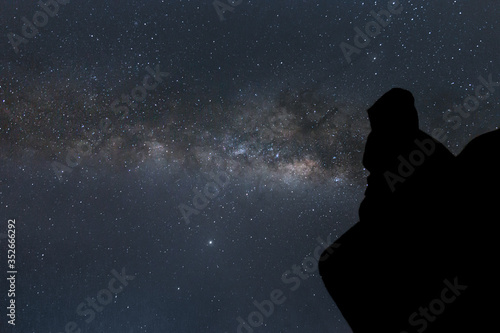 silhouette of person gazing the galactic center of the milky way