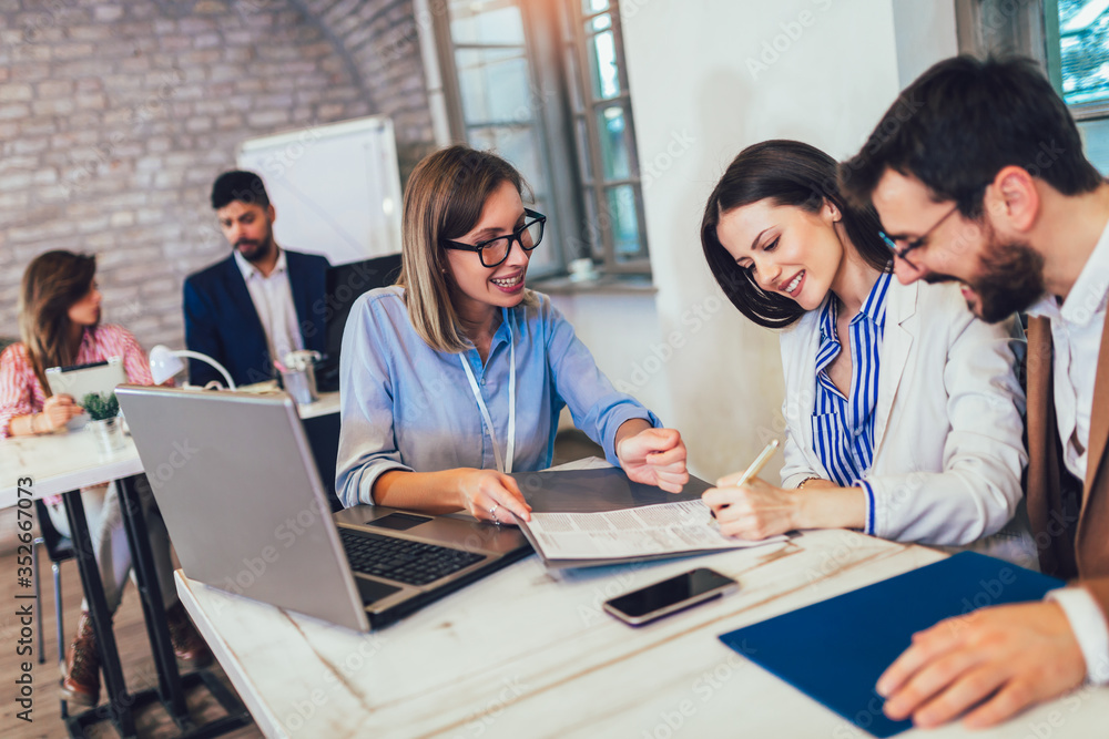 Young couple signing a contract on a meeting with investment agent in the office. Young couple signing a contract on a meeting with investment agent in the office.