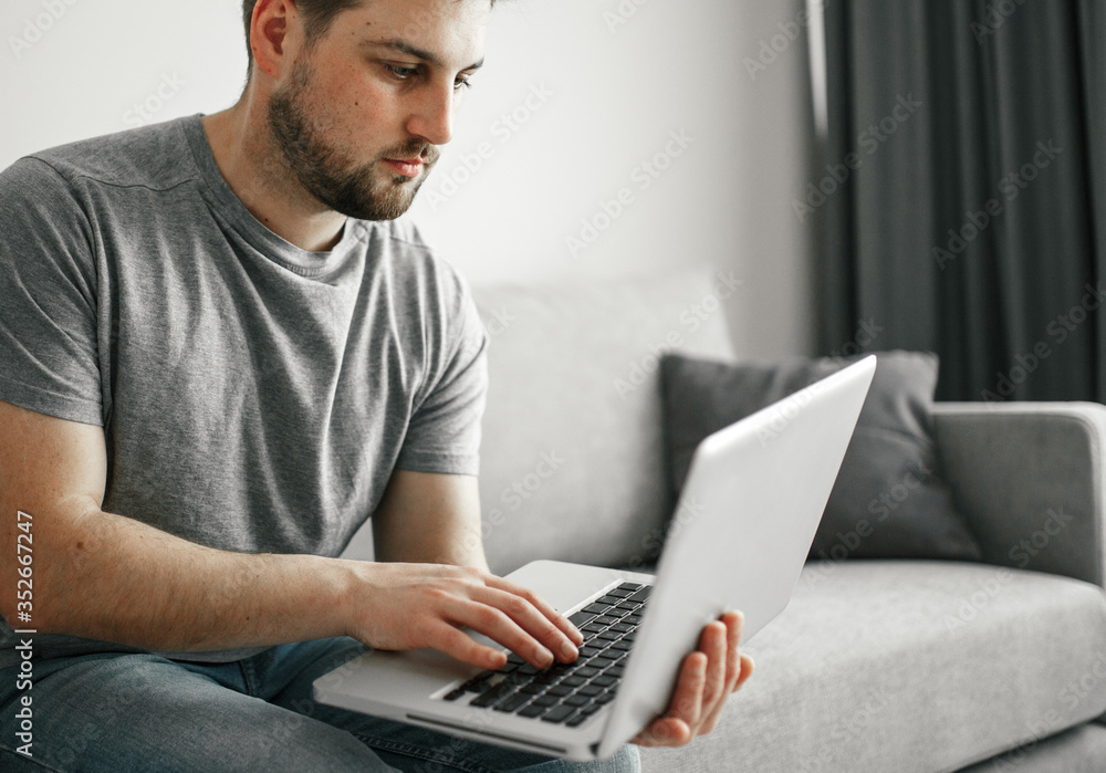 Young man with medical mask working home online at quarantine Young man with medical mask working home online at quarantine