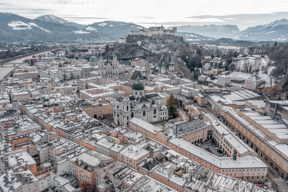 Aerial drone shot view of snowy salzburg city center with view of Cathdrals and fortress in winter Aerial drone shot view of snowy salzburg city center with view of Cathdrals and fortress in winter
