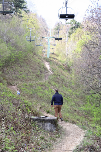 Family walk or hike through the mountain forest in early spring photo