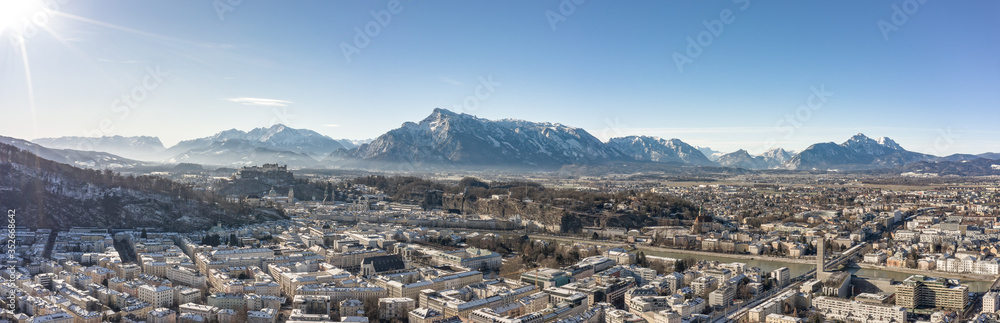 Panoramic aerial drone view of Salzburg snowy north town with view of Unesberg mountain in winter morning
