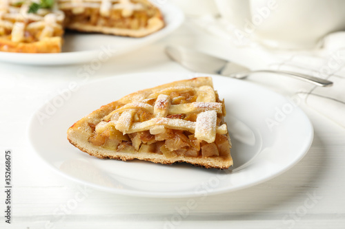 Composition with apple pie on white wooden background. Tasty lunch. Homemade breakfast © Atlas