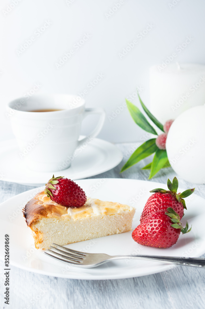 Cheesecake with strawberries on a white plate. Cheesecake with strawberries on a white plate.