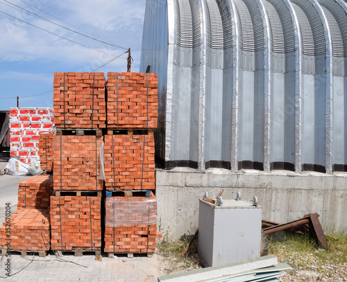 Warehouse of building materials. Building base, metal, wood and blocks with bricks.