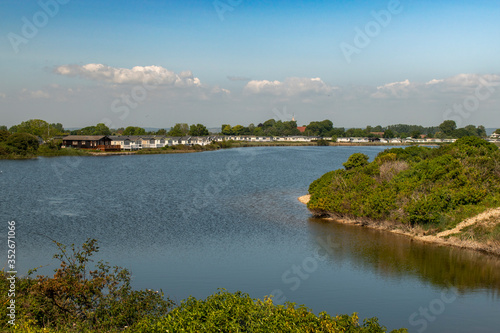 Pagham Lagoon footage with Church Farm Holiday Park on the far bank.