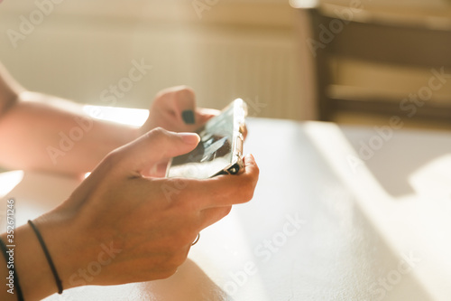 Hands holding a mobile phone in landscape mode