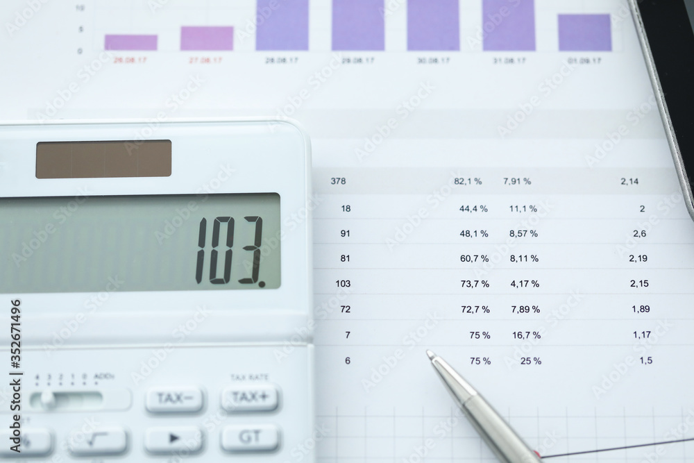 On report with numbers lies calculator and pen On report with numbers lies calculator and pen
