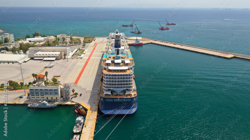 Aerial top view wide photo of huge cruise liner with pool facilities docked in Mediterranean port