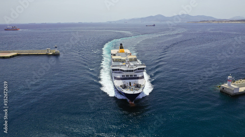 Obraz na plátne Aerial drone photo of passenger ferry reaching destination - busy port of Piraeu