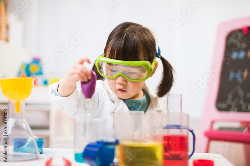 toddler girl pretend play scientist role for homeschooling