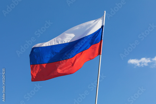 Flag of Russia developing against the blue sky Free Download Flag of Russia developing against the blue sky - GFXLoad