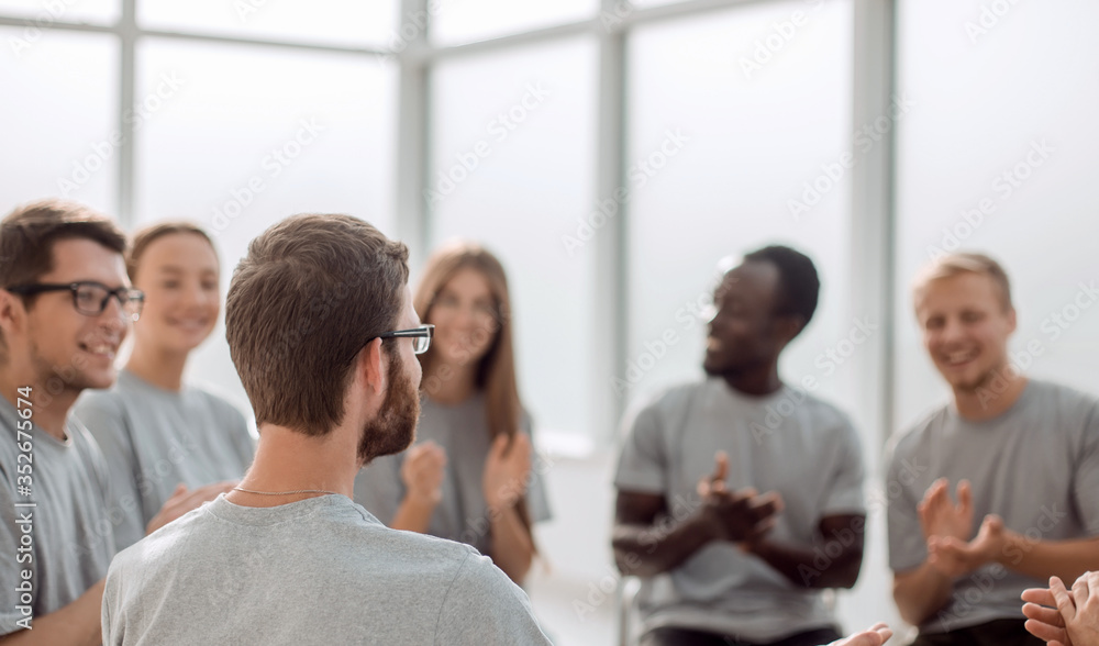 young people are discussing something sitting in a circle. young people are discussing something sitting in a circle.